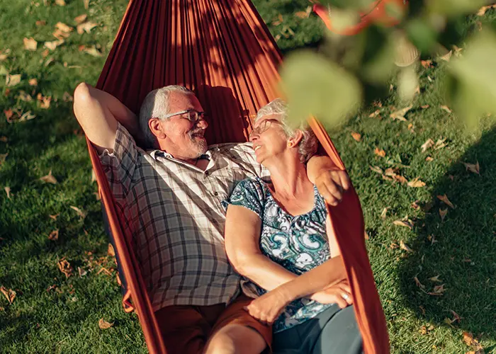 Retired couple napping in hammock