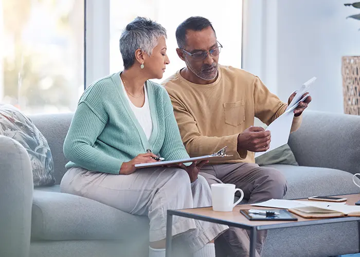 Retirement age couple going over financial documents