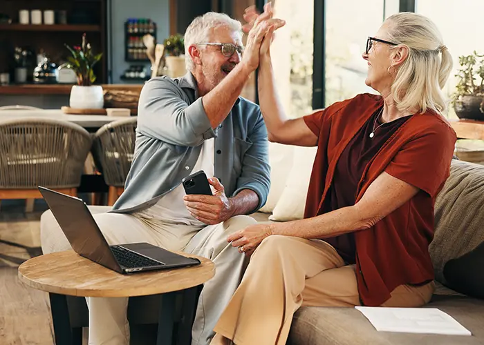 Retirement age couple high-fiving