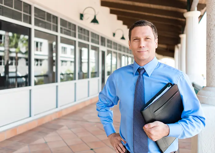 Male insurance agent with tie and portfolio